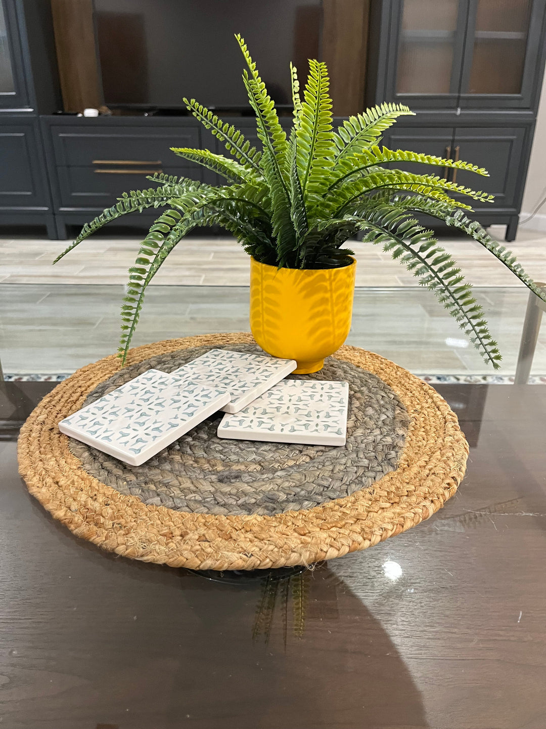 Round jute placemats set of four with candles and greenery on dining table